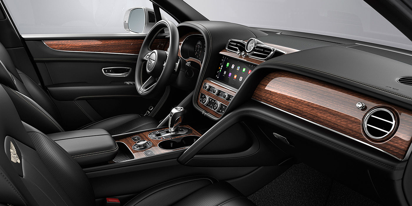 Bentley New Delhi Bentley Bentayga interior with a Crown Cut Walnut veneer, view from the passenger seat over looking the driver's seat.